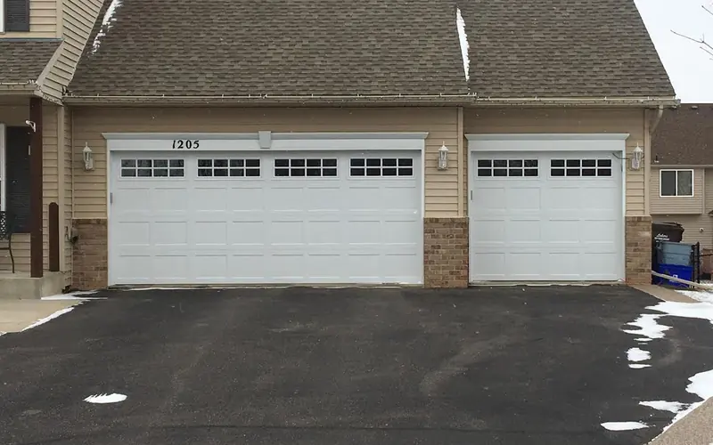 White double and single garage doors with rectangular top windows